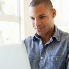 Man looking over a laptop.